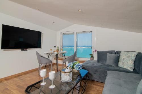 a living room with a couch and a table at Minimal Loft with Sea View over Zakynthos Harbor! in Zakynthos Town