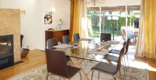 a dining room with a table and chairs and a fireplace at Aroeira Villa near Lisbon- Daydream PT in Charneca