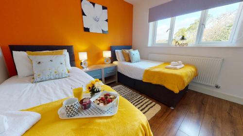 um quarto com duas camas e uma bandeja de comida em Beautiful & Spacious with 2 Free Parking Spaces - SRK Accommodation em Peterborough