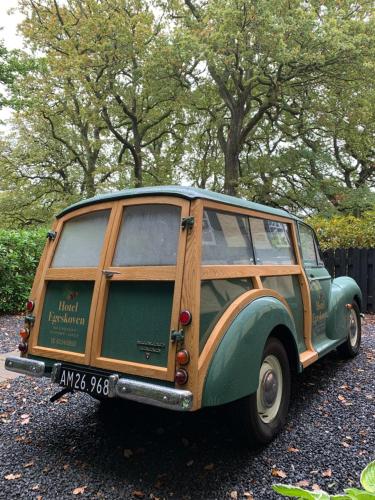 a green and wooden van parked in a parking lot at Hotel Egeskoven in Viborg