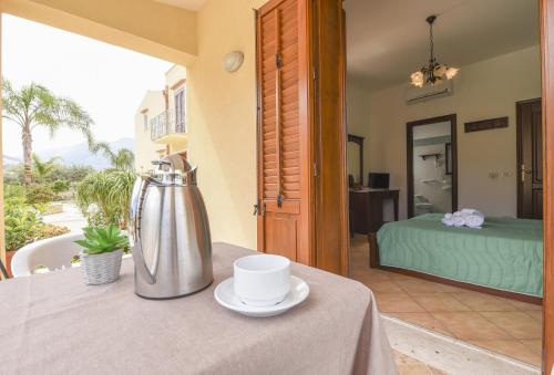 a table with a coffee pot and a cup on it at Aurora Castelluzzo in Castelluzzo