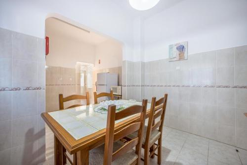 a dining room with a table and chairs at Villas Brites nº2 in Burgau