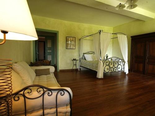 a bedroom with two beds and a wooden floor at Domaine Lespoune in Castetnau-Camblong