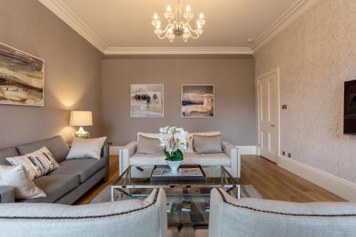 a living room with a couch and a table at Exclusive 2 Bed, Free Private Parking, in West End in Edinburgh