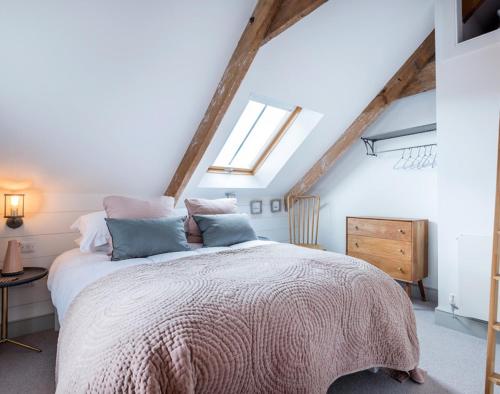 a bedroom with a large bed in a attic at Albany in Port Isaac
