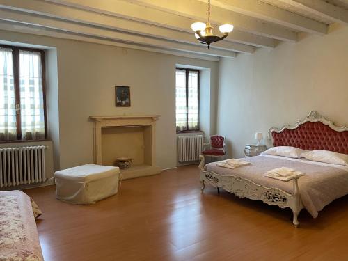 a large bedroom with a bed and a fireplace at Casa San Martino in Volta Mantovana