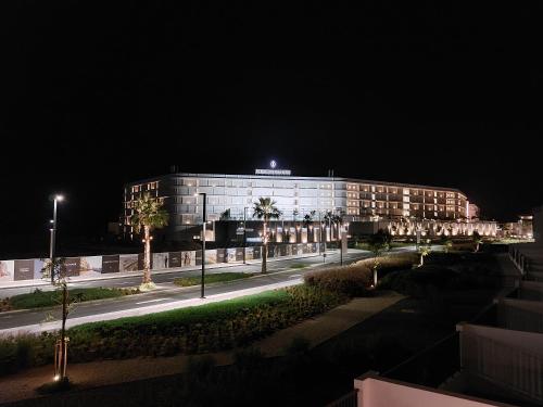 a building at night with a street in front of it at Marbella Luxury 3BR & 5BR Villas at Hayat Island, Mina Al Arab in Ras al Khaimah