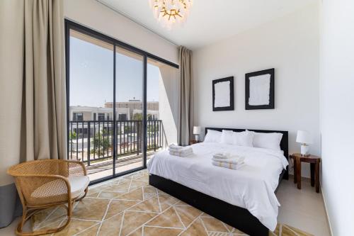 a bedroom with a large bed and a large window at Marbella Luxury 3BR & 5BR Villas at Hayat Island, Mina Al Arab in Ras al Khaimah