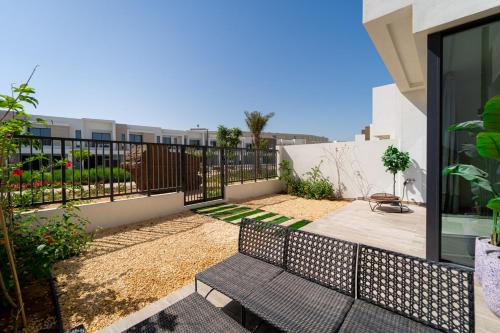 a patio with two benches and a fence at Marbella Luxury 3BR & 5BR Villas at Hayat Island, Mina Al Arab in Ras al Khaimah