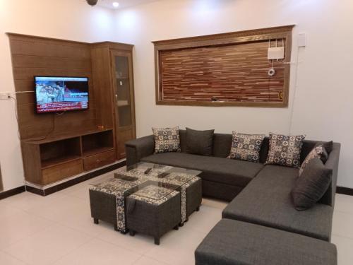 salon z kanapą i telewizorem w obiekcie Dream Villa w mieście Islamabad