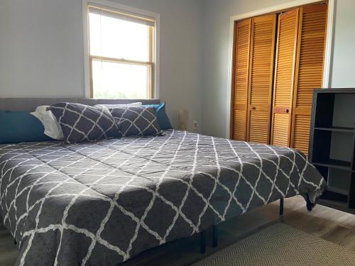 a bedroom with a bed and a window at Beach House on Lake in Terre Haute