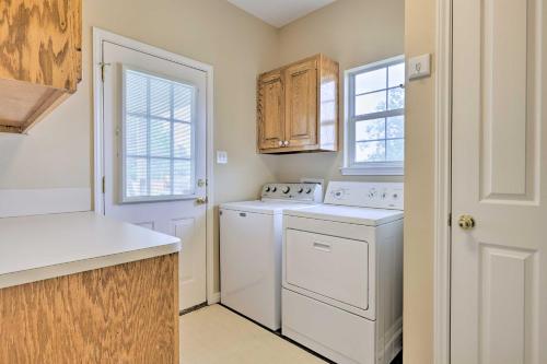 a kitchen with a washer and dryer and a window at Fox Ridge Farmhouse - Hill Country Getaway! in San Marcos