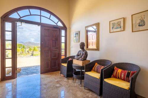 a statue sitting on a table in a room at Cliff Villa - Award Winning Luxury Retreat in Westpunt