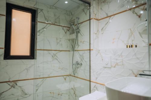 a bathroom with a sink and a glass shower at Villa Afrodita Lake View in Ohrid