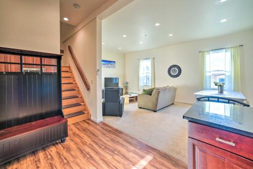 a kitchen and living room with a couch and stairs at half Mi to Windham Mtn Main Street Condo in Windham