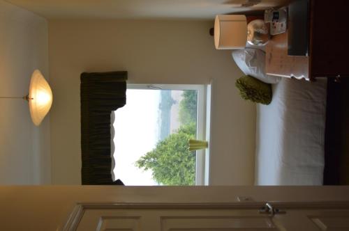 a bathroom mirror with a view of a window at The Grange Court B&B Hotel in Rockbeare