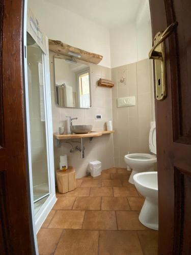 a bathroom with a sink and a toilet and a mirror at Casa Amata in Lecco