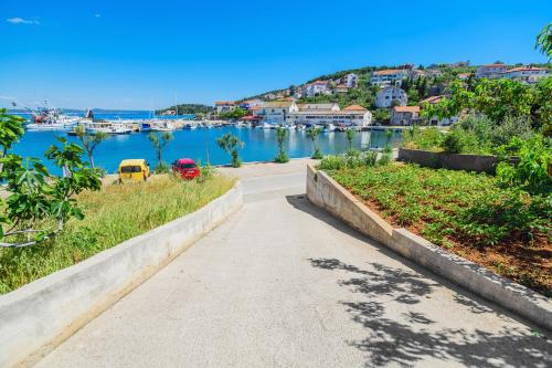 a walking path next to a body of water at Stone house on the Batalaža Beach - Kali in Kali