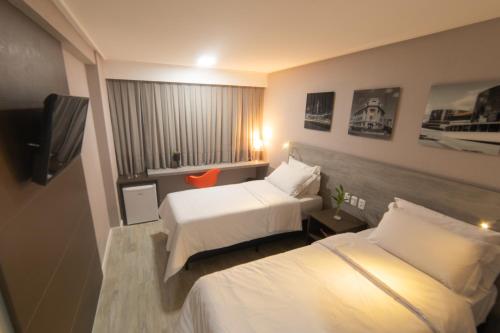 Un pat sau paturi într-o cameră la Intercity Campina Grande Citymix