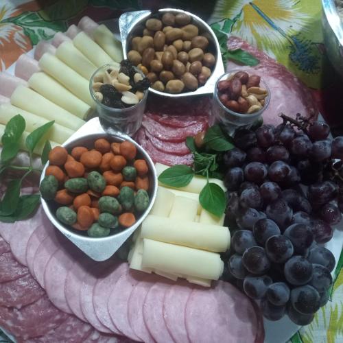 a tray of cheese and other foods on a table at Bistrô Pousada Savacipó in Serra do Cipo