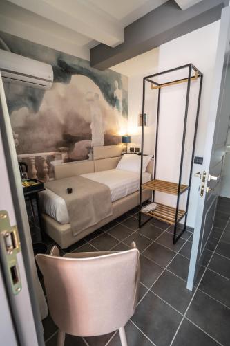 a room with a bed and a chair in it at Relais Manzoni in Rome
