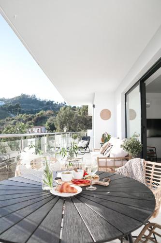 a wooden table with a plate of food on it at Balcon Del Mar Nerja in Nerja