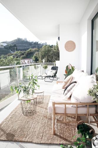 a living room with a bed and a balcony at Balcon Del Mar Nerja in Nerja