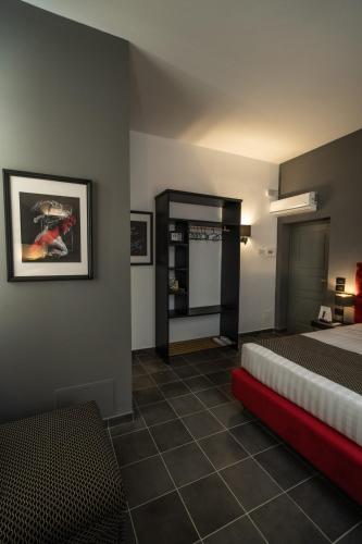 a bedroom with a bed with a red bench in it at Relais Manzoni in Rome