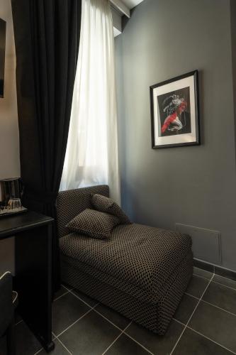 a room with a chair and a window at Relais Manzoni in Rome