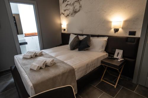 a hotel room with a bed with towels on it at Relais Manzoni in Rome