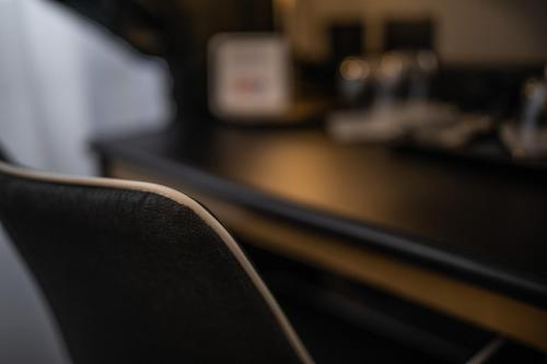 a black chair sitting in front of a counter at Relais Manzoni in Rome