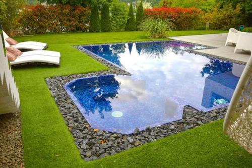 a swimming pool in a yard with green grass at Private Family Villa in Budaörs