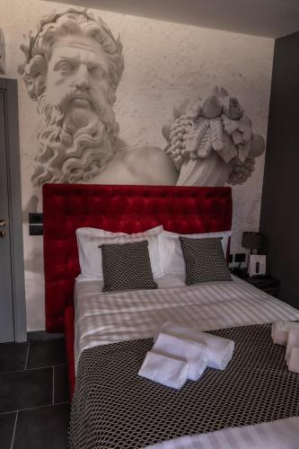 a statue of a bust of a man next to a bed at Relais Manzoni in Rome
