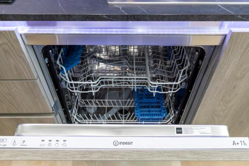 an open dishwasher withabling inside of it at The Queen Luxury Apartments - Villa Medici in Luxembourg