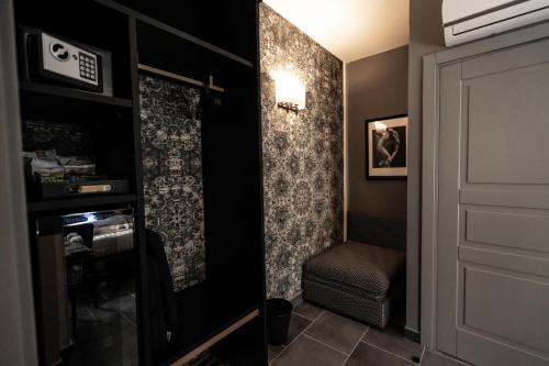 a room with a closet with a chair and a door at Relais Manzoni in Rome