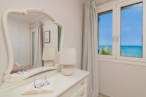 a bathroom with two sinks and a mirror at Villa Elizabeth - Seafront Classic Villa! in Zakynthos Town