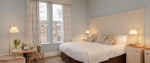 a bedroom with a large bed and a window at Gregory by the Warren Collection in Belfast