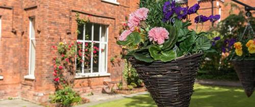 a basket filled with flowers in front of a building at Gregory by the Warren Collection in Belfast