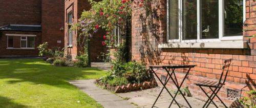 a brick house with a window with flowers on it at Gregory by the Warren Collection in Belfast
