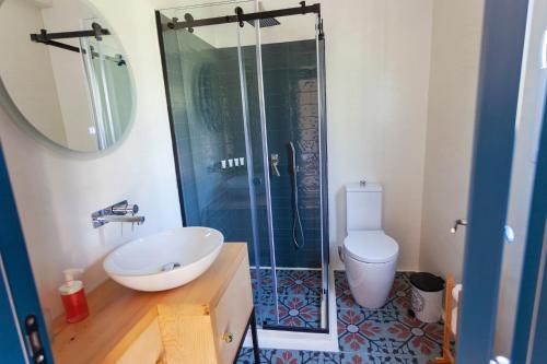 a bathroom with a shower and a sink and a toilet at Toni Retzo Rooms in Himare