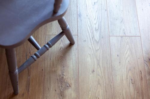 a chair sitting on top of a wooden floor at Toni Retzo Rooms in Himare