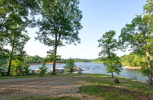 a dock on a lake with a boat in the water at Rough River Dam State Resort Park in Fentress McMahan