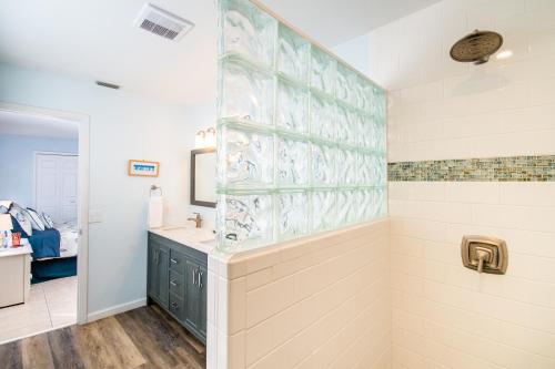 a bathroom with a shower and a sink at Beach Potato - 3404 Gulf Dr 5 in Holmes Beach