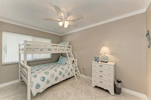 a bedroom with a bunk bed and a ceiling fan at AMI Dreaming - 4200 Gulf 105 in Holmes Beach