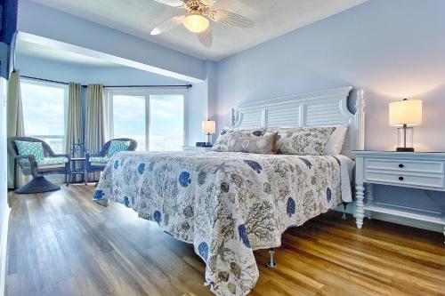 a bedroom with a bed with a white bedspread at Water View 506 in Clearwater Beach
