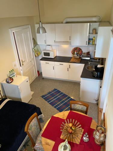 a kitchen with a table and a kitchen with a kitchen at Nationalpark Lobau Wohnung in Groß-Enzersdorf