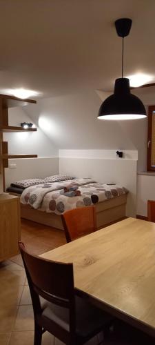 a bedroom with a bed and a table and a dining room at Apartment Markič in Bohinj