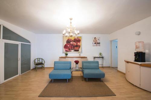 a living room with two blue chairs and a table at Villa Bejar Cuernavaca in Cuernavaca