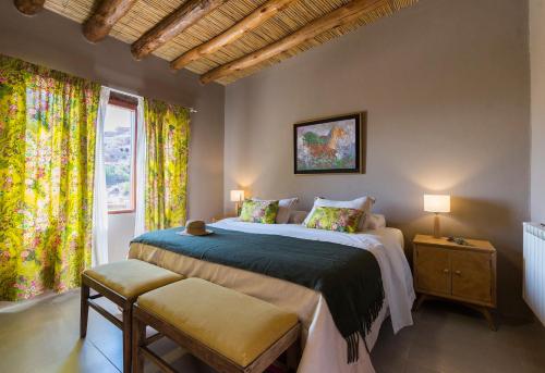 a bedroom with a large bed and a window at Villa del Cielo in Tilcara