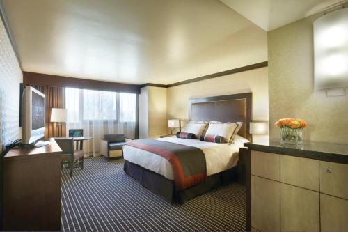 a hotel room with a bed and a television at Cactus Petes Resort & Horseshu Hotel in Jackpot